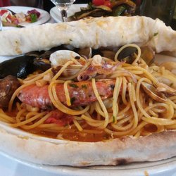 Seafood pasta covered in pizza dough