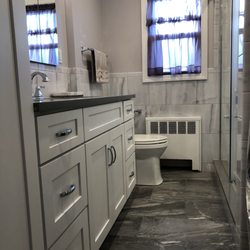 AGP Kitchen & Bath Design - Grey bathroom with white vanity and linen closet.