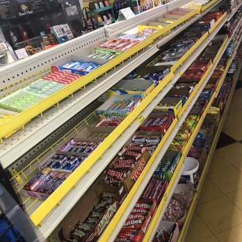 4 Your Convenience - a grocery store aisle filled with candy and candy bars - Grocery Near Me - Medford, New York