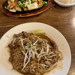 a plate of noodles and meat