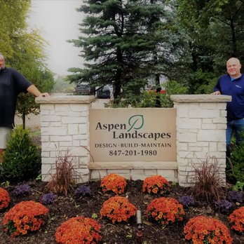 Aspen Landscapes - two men standing in front of a sign - Landscaping Near Me - Grayslake, Illinois Aspen Landscapes - two men standing in front of a sign - Landscaping Near Me - Grayslake, Illinois