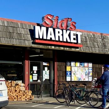 Sid's Market - a man walking in front of a store - Grocery Near Me - Seaview, Washington