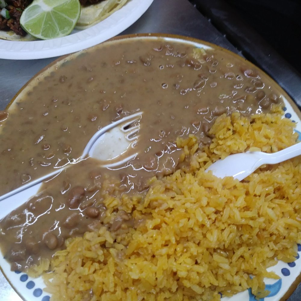 Adobada tacos with a side of rice and beans. Adobada tacos with a side of rice and beans.