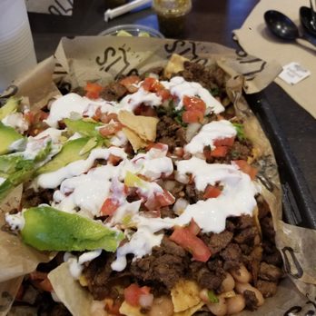 Oli's Tacos - 1st visit..look at how much asada is there. Sour cream here is not all over my nachos - Tacos Near Me - Montclair, California