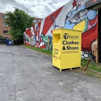 Riggs Wine & Liquor - a yellow box in front of a graffiti covered building - Beer, Wine & Spirits Near Me - Washington, DC, District of Columbia