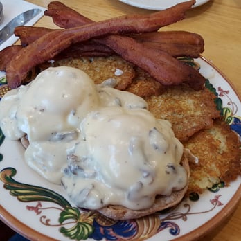 Oak Table Cafe - Eggs Benny - country style gravy over poached eggs and sausage patties on english muffins and potato pancakes. With side thick cut bacon. - New American Near Me - Silverdale, Washington Oak Table Cafe - Eggs Benny - country style gravy over poached eggs and sausage patties on english muffins and potato pancakes. With side thick cut bacon. - New American Near Me - Silverdale, Washington