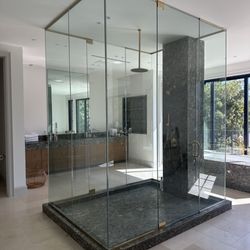 Glass Queen - Custom gorgeous primary bath shower enclosure with unlaquered brass hardware #lovesstudiocity