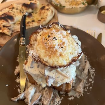 Motek - Boca Raton - Mushrooms in cram sauce over a thick slice of Japanese bread ( non sweet Chaka) with sunny side up egg, and parm cheese.  Was different. - Mediterranean Near Me - Boca Raton, Florida