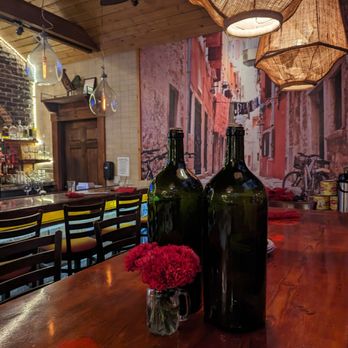 Davanti Enoteca - Del Mar - two empty wine bottles on a wooden table - Italian Near Me - Del Mar, California Davanti Enoteca - Del Mar - two empty wine bottles on a wooden table - Italian Near Me - Del Mar, California
