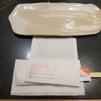 Restaurant SUNTORY - Chopsticks, plate, napkin and a bag placed down on the table for each customer. - Japanese Near Me - Honolulu, Hawaii Restaurant SUNTORY - Chopsticks, plate, napkin and a bag placed down on the table for each customer. - Japanese Near Me - Honolulu, Hawaii