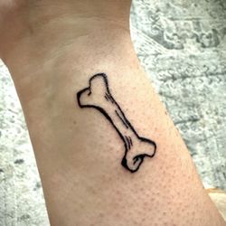 Elite Ink Tattoo Studios - A tattoo of a bone.