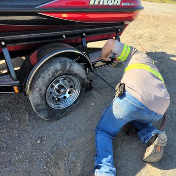 T & W Tire - Jay jacking up the trailer to put our spare on it. - Tires Near Me - Mcalester, Oklahoma T & W Tire - Jay jacking up the trailer to put our spare on it. - Tires Near Me - Mcalester, Oklahoma