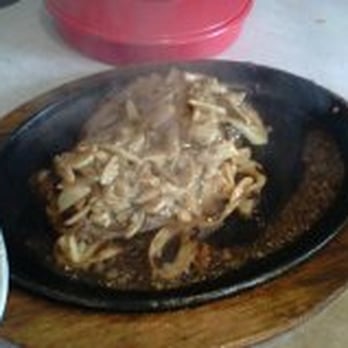 Yucatan Grill - Sizzling Tenderloins with Mojo (that's smoke coming off the cast iron pan) - Caribbean Near Me - Seal Beach, California