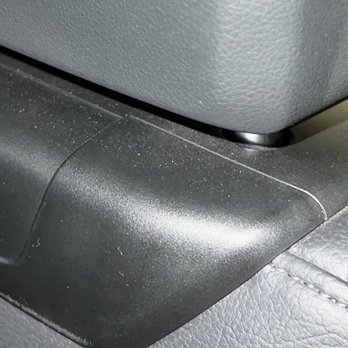 Ceramic Garage - A detailed close-up of a textured gray plastic surface with visible dust particles and a black base or trim. - Car Window Tinting Near Me - Modesto, California