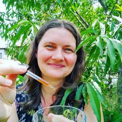 The Barefoot Dragonfly - Wellness practitioner and educator Amy Kreydin under the peach tree.
