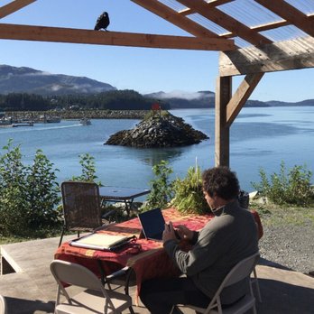 Homegrown - a man sitting at a table with a laptop - Food Trucks Near Me Homegrown - a man sitting at a table with a laptop - Food Trucks Near Me