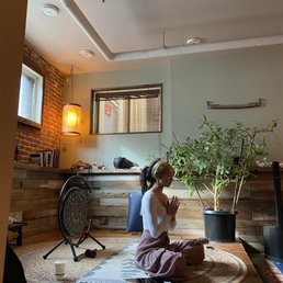 a woman sitting on the floor in a living room a woman sitting on the floor in a living room