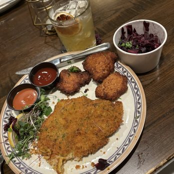 Rathskeller - Schnitzel, potato cakes, red cabbage and the I fall for you cocktail. - German Near Me - Elkridge, Maryland