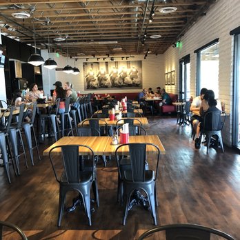 Sauce Pizza & Wine - a restaurant with tables and chairs - Pizza Near Me - Phoenix, Arizona