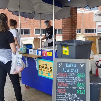 Dave’s Al-A Cart - ows a woman standing under an umbrella - Street Vendors Near Me - Glen Allen, Virginia