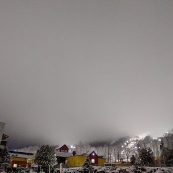 Bromont Montagne D’Experiences - Beautiful scenery of lit up skies and mountains concealed by falling snow - Ski Resorts Near Me - Bromont, Quebec