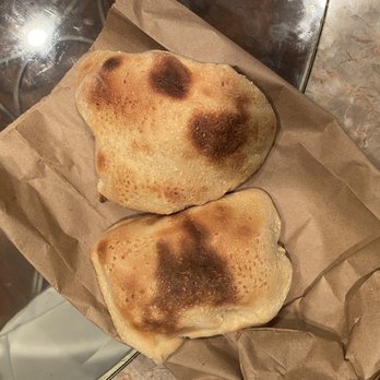 Pita Cafe - two pieces of bread on a brown paper bag - Middle Eastern Near Me - Oak Park, Michigan