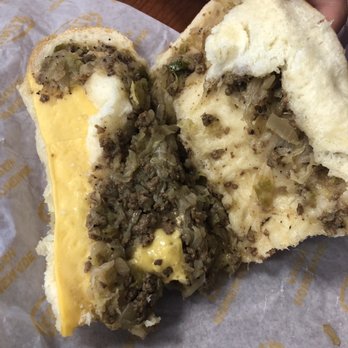 Runza - a person holding a half eaten sandwich - Burgers Near Me - Papillion, Nebraska Runza - a person holding a half eaten sandwich - Burgers Near Me - Papillion, Nebraska