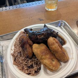 Jerk chicken with plantains, Jamaican rice and beans, and fried dough Jerk chicken with plantains, Jamaican rice and beans, and fried dough
