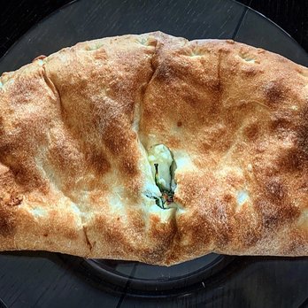 Pizza Suprema - Need a bigger plate for this monstrous spinach calzone - Pizza Near Me - Lutz, Florida Pizza Suprema - Need a bigger plate for this monstrous spinach calzone - Pizza Near Me - Lutz, Florida