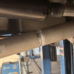 Suburban Tire Auto Repair Center - this is how they left my exhaust and axle for me to drive.