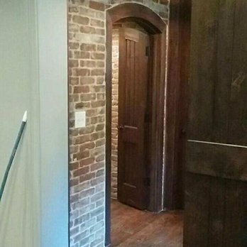 Eagle Designs - a brick wall and hardwood floors - Roofing Near Me Eagle Designs - a brick wall and hardwood floors - Roofing Near Me