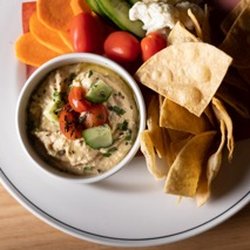 Home & Away - House-made hummus with warm tortilla chips and fresh veggies.