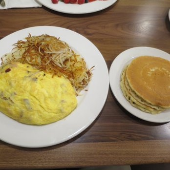 Brunch Cafe-Niles - Gigantic meat lovers omelette, with sides of pancakes and shredded hash browns. - Breakfast & Brunch Near Me - Niles, Illinois