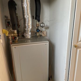 Budget Water Heaters - Noritz tankless water heater installed to code inside kitchen hallway. - Water Heater Installation/Repair Near Me Budget Water Heaters - Noritz tankless water heater installed to code inside kitchen hallway. - Water Heater Installation/Repair Near Me