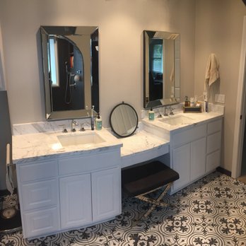 AJ Houston Construction - Dual sinks in the Master Bathroom with Carrara countertop and backsplash.  Love this floor tile. - General Contractors Near Me