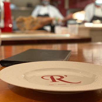 The Revolution - a plate on a table with a menu in the background - Cocktail Bars Near Me - New Orleans, Louisiana