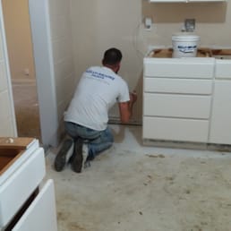 Erik cutting in around the cabinets Erik cutting in around the cabinets