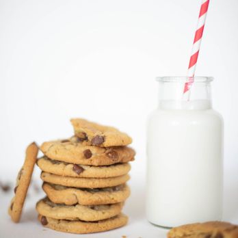 Becky Bakes - a stack of chocolate chip cookies next to a glass of milk - Desserts Near Me - New Ulm, Minnesota