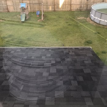 Trugreen - a view of a backyard from a window - Lawn Services Near Me