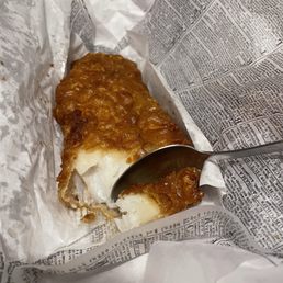 a piece of fish and chips in a wrapper a piece of fish and chips in a wrapper