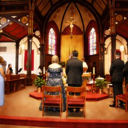 Bride and Groom on altar with their grown family next to them renewing their vows