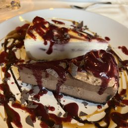 a chocolate cheesecake on a white plate a chocolate cheesecake on a white plate