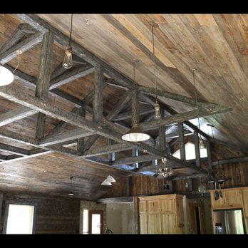 Q United - a ceiling with wooden beams and lights - General Contractors Near Me Q United - a ceiling with wooden beams and lights - General Contractors Near Me
