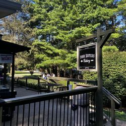 Four Sisters Bakery - Sign and outside patio where customers