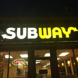 a subway sign in the window of a subway a subway sign in the window of a subway