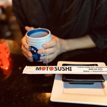 Moto Sushi - a woman holding a cup of coffee - Japanese Near Me - Glendale, California Moto Sushi - a woman holding a cup of coffee - Japanese Near Me - Glendale, California