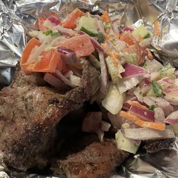 Les delices de Awa - Lamb dish with pickled veggies stuff on it. - African Near Me - Madison, Wisconsin Les delices de Awa - Lamb dish with pickled veggies stuff on it. - African Near Me - Madison, Wisconsin