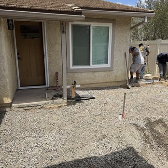 Big E Masonry Solutions - finishing stamping the concrete and gravel prepped for pavers.Most important subject in the photo? The Big Boss getting his hands dirty! - Masonry/Concrete Near Me