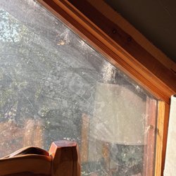 Log Country Cove - Loft window with dirt and cobwebs
