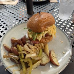 Breakfast sandwich with a side of potatoes Breakfast sandwich with a side of potatoes
